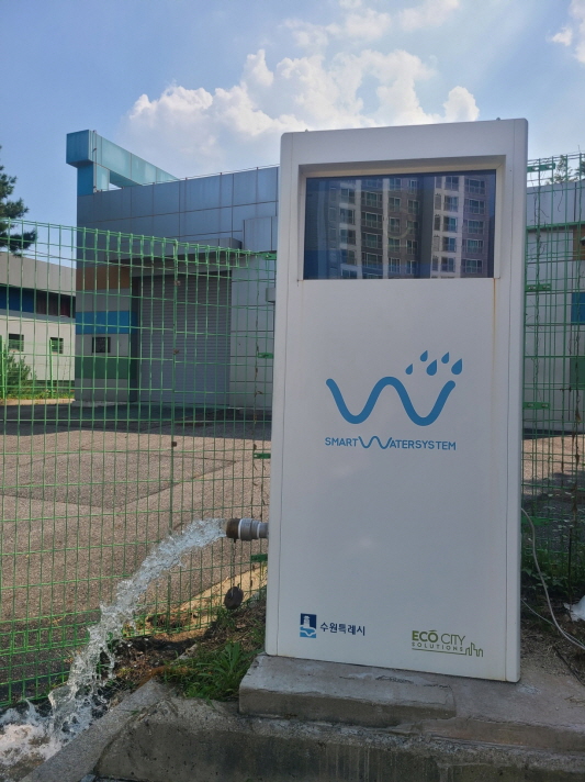 빗물공급기에서 모아둔 빗물이 나오고 있다.